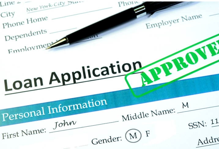 Loan application with approved stamp on it