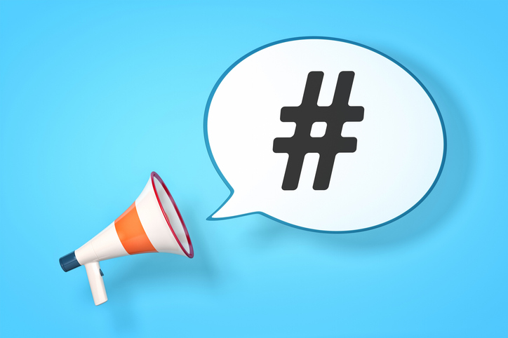 A megaphone with a speech bubble and the message hashtag